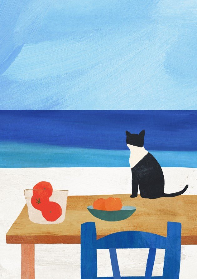 Cat sitting at a table with fruit, looking out over a blue ocean. framed